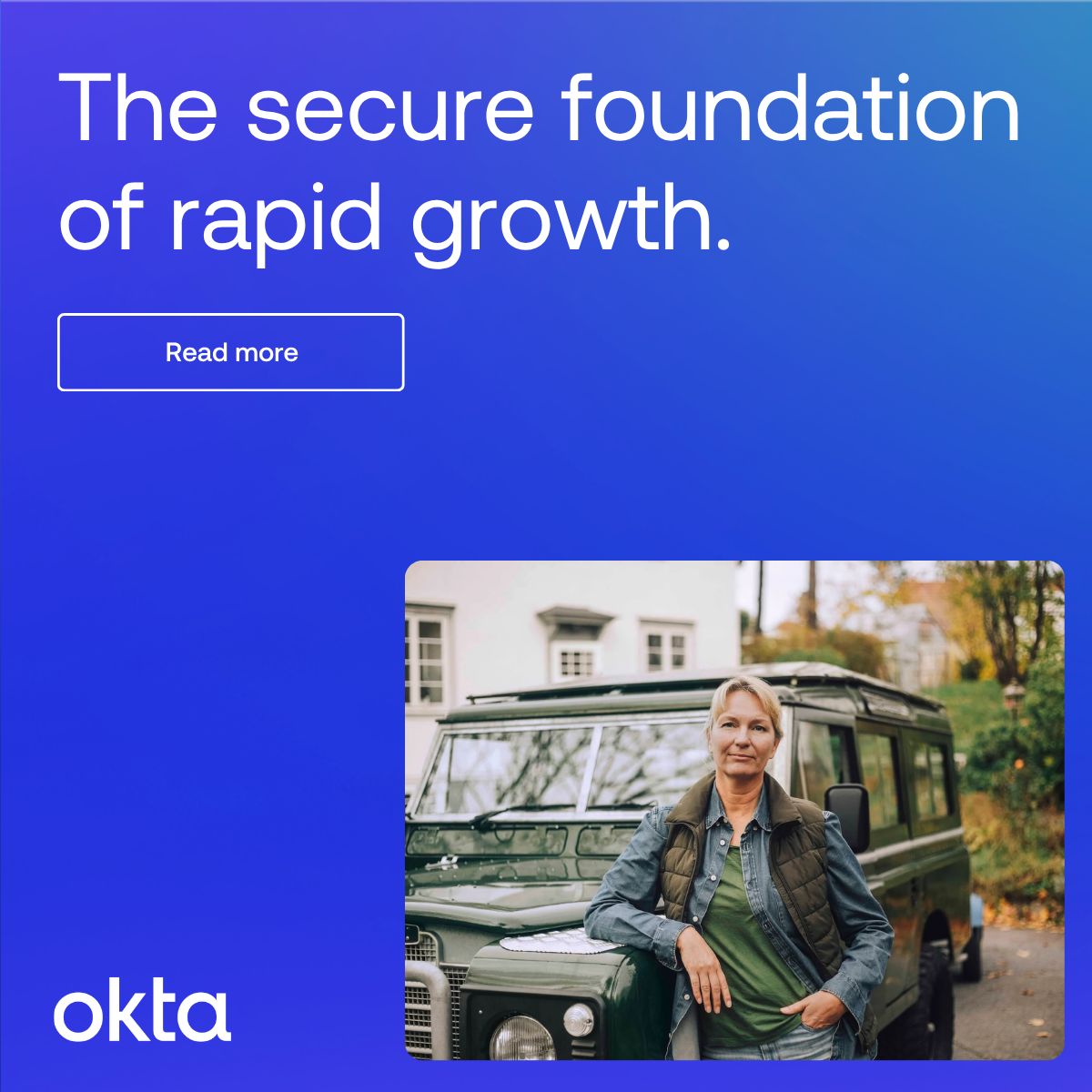 Okta brand awareness ad on a blue gradient background. The headline in large white text reads "The secure foundation of rapid growth." A white-outlined "Read more" CTA button appears below. The lower right features a photo of a woman leaning against a vintage Land Rover in an outdoor setting. The Okta logo is placed in the bottom left corner.